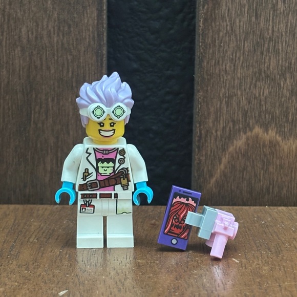 Lego Scientist Minifigure with Purple Hair and Blue Gloves from set number 70418 - Picture 1 of 3